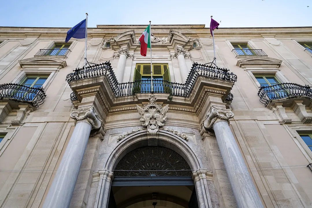 ornate-building-facade-with-flags-on-top ornate-building-facade-with-flags-on-top